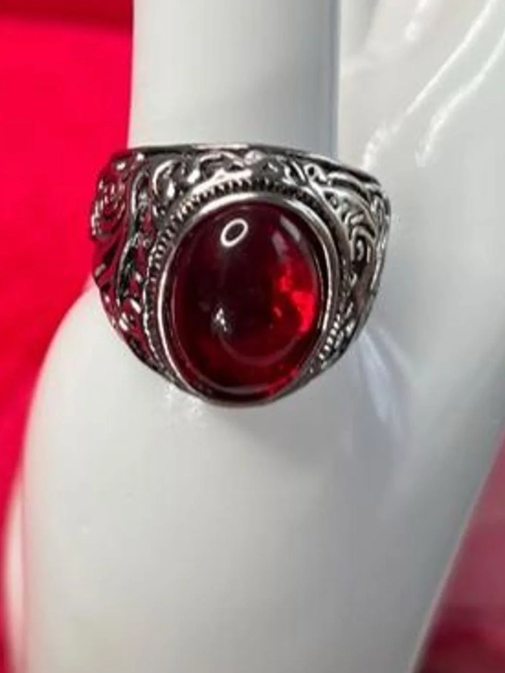 Red ruby gemstone ring with silver filigree detailing